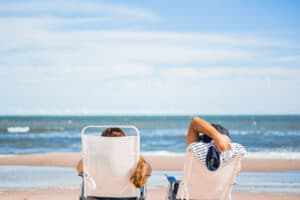 two people tanning on a beach